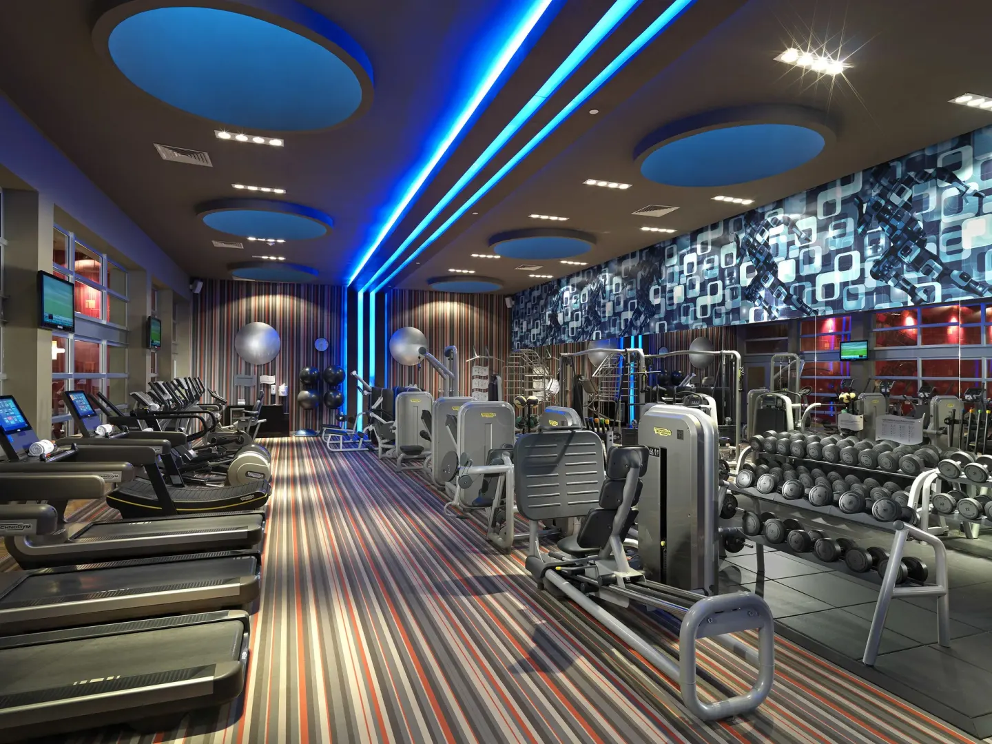 Fitness center with cardio machines, weights, and blue ceiling lights at Paradisus La Perla Riviera Maya.