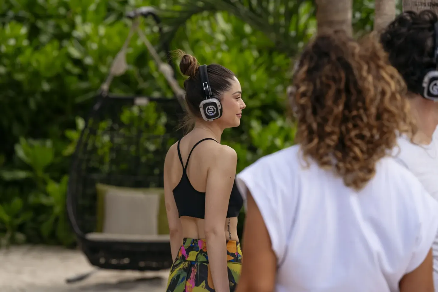 Guests wearing headphones during an outdoor wellness activity at Paradisus La Perla Riviera Maya.