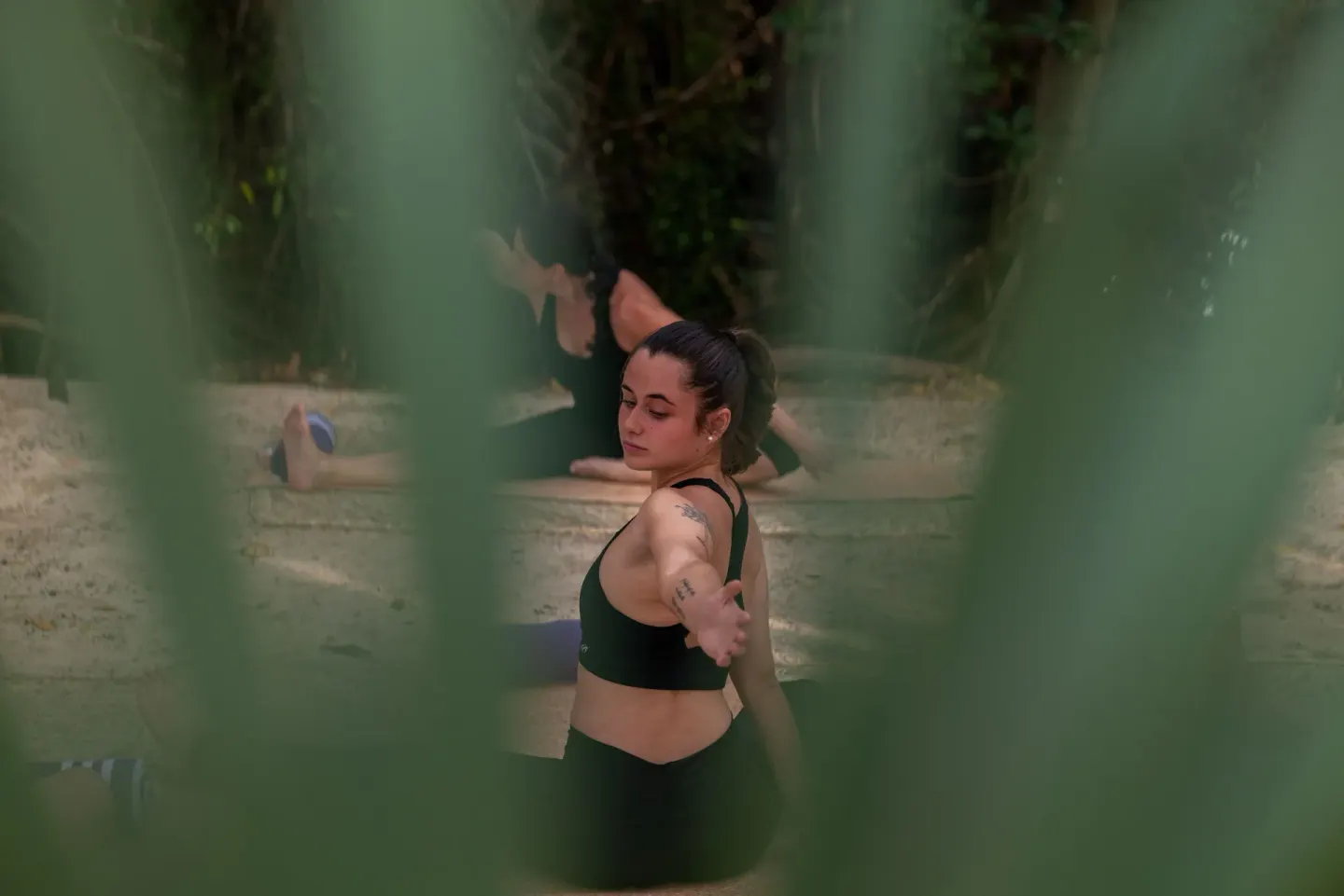 A guest stretches during an outdoor yoga session at Paradisus La Perla Riviera Maya.