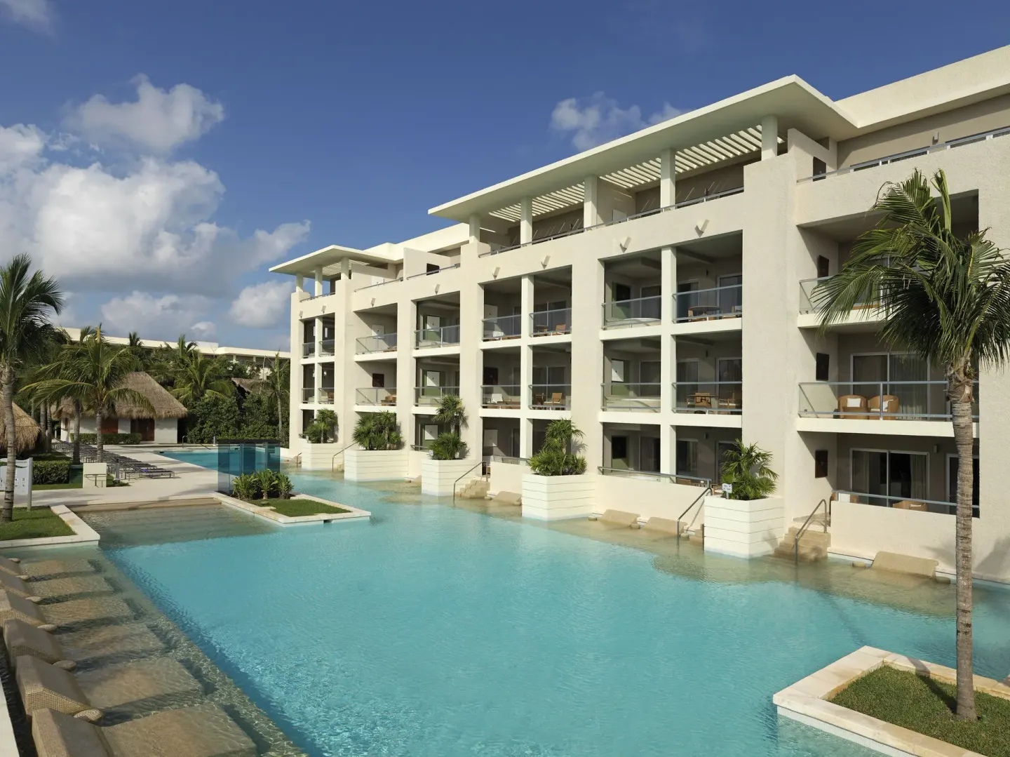 Swim-up pool beside balconied resort rooms at Paradisus La Perla Riviera Maya.
