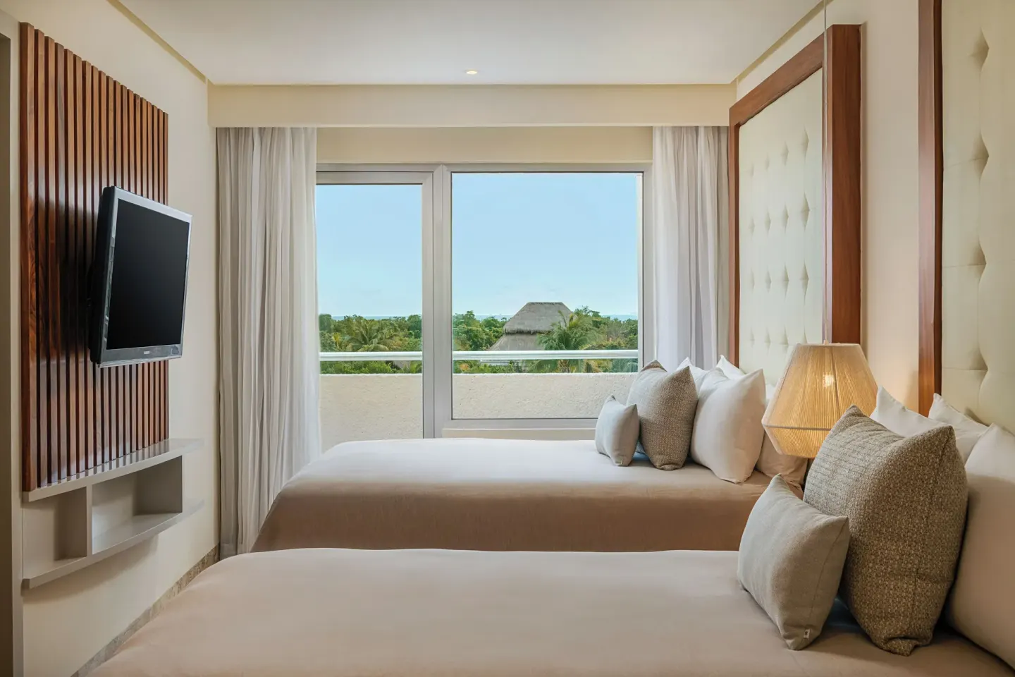 Suite Nature View bedroom with two beds and balcony greenery at Paradisus La Perla Riviera Maya.