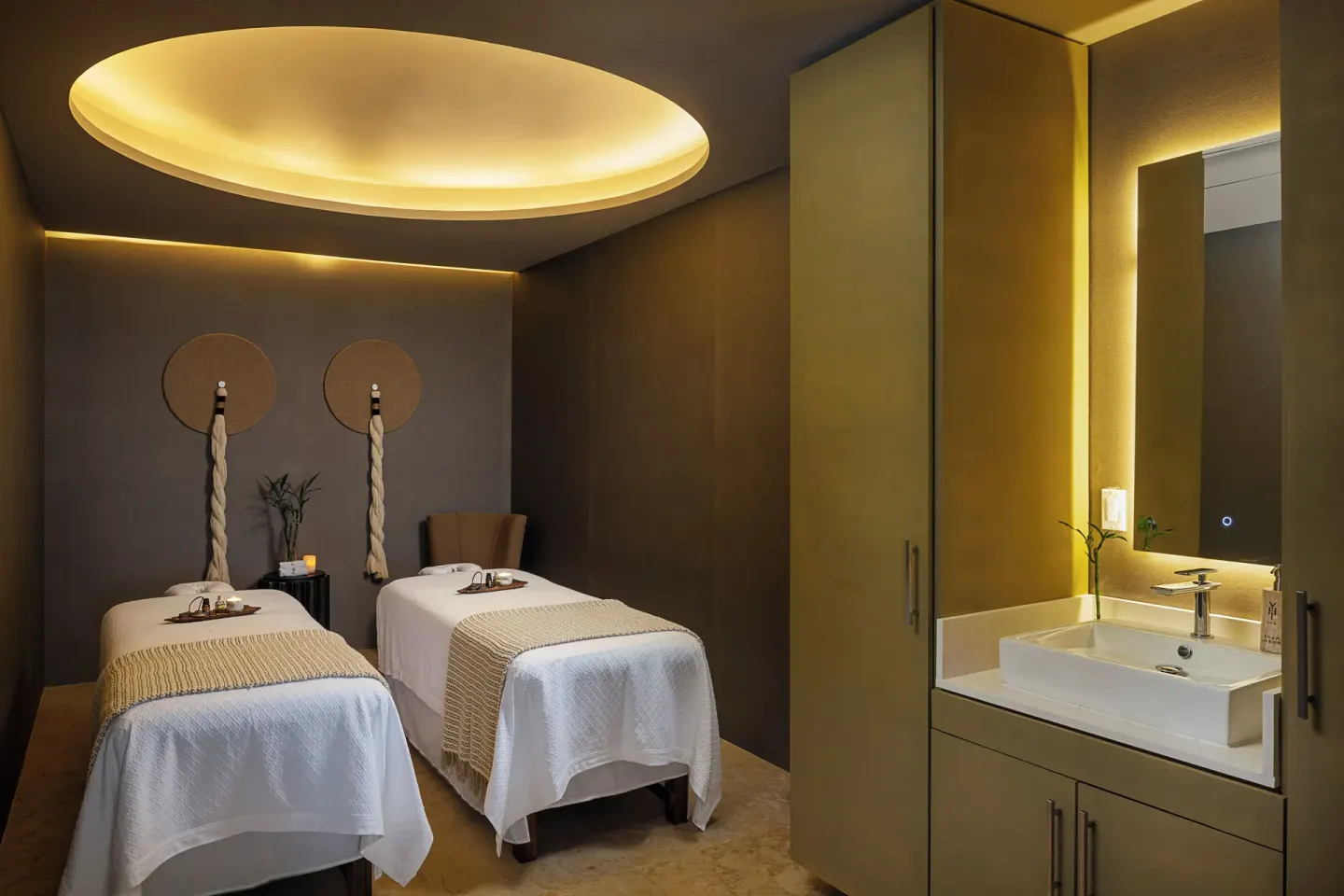 Two spa treatment beds and a vanity sink at Paradisus Los Cabos.