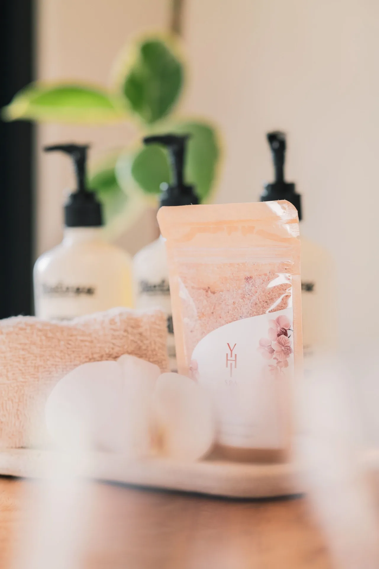 Close-up of bath amenities with towels and a bath product pouch at Paradisus Los Cabos.