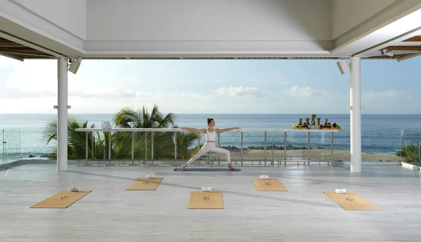 Ocean-view yoga setup on a covered terrace at Paradisus Los Cabos.