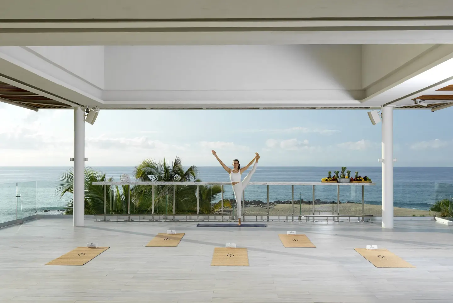 Yoga instructor on an oceanfront terrace at Paradisus Los Cabos.