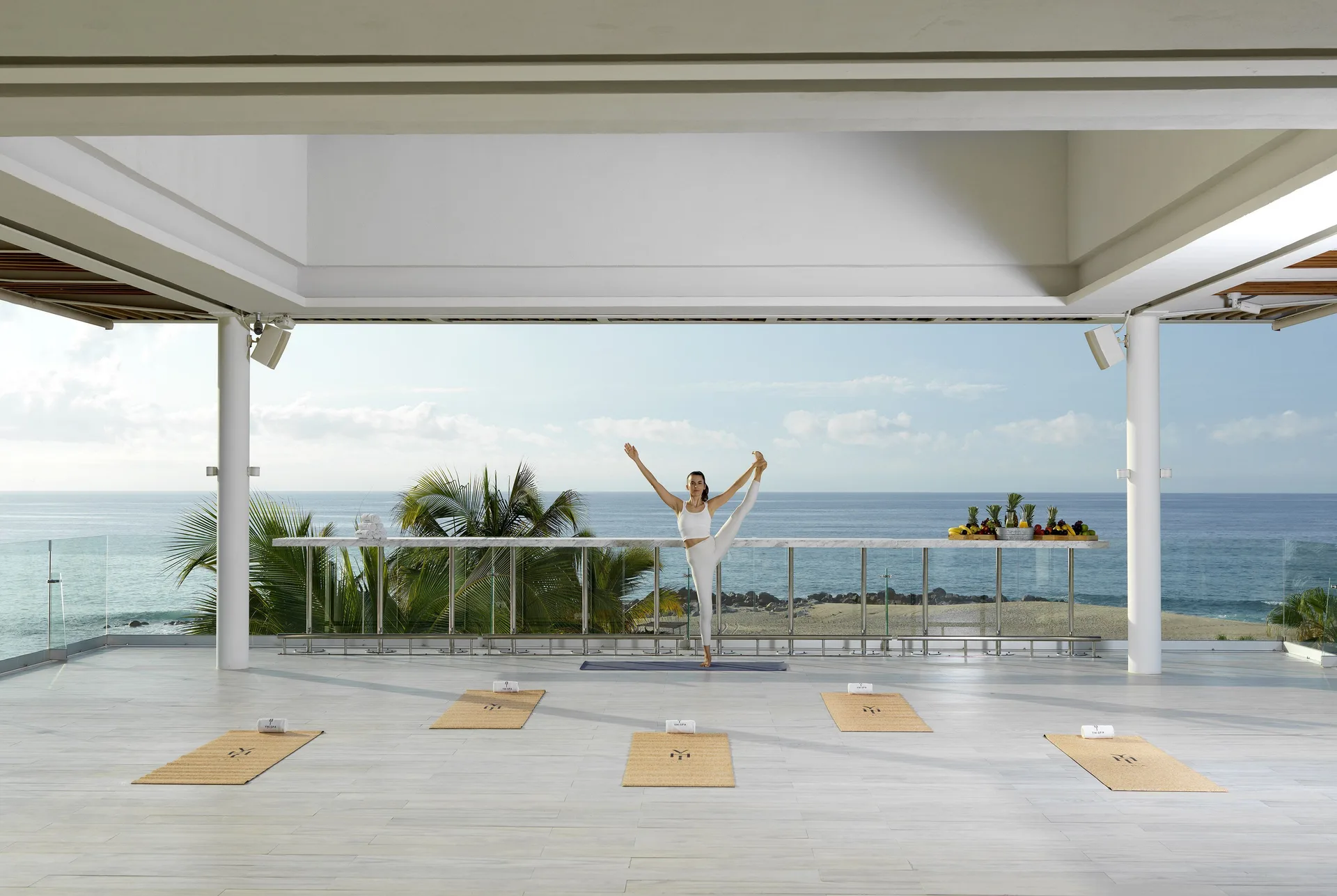Yoga instructor on an oceanfront terrace at Paradisus Los Cabos.
