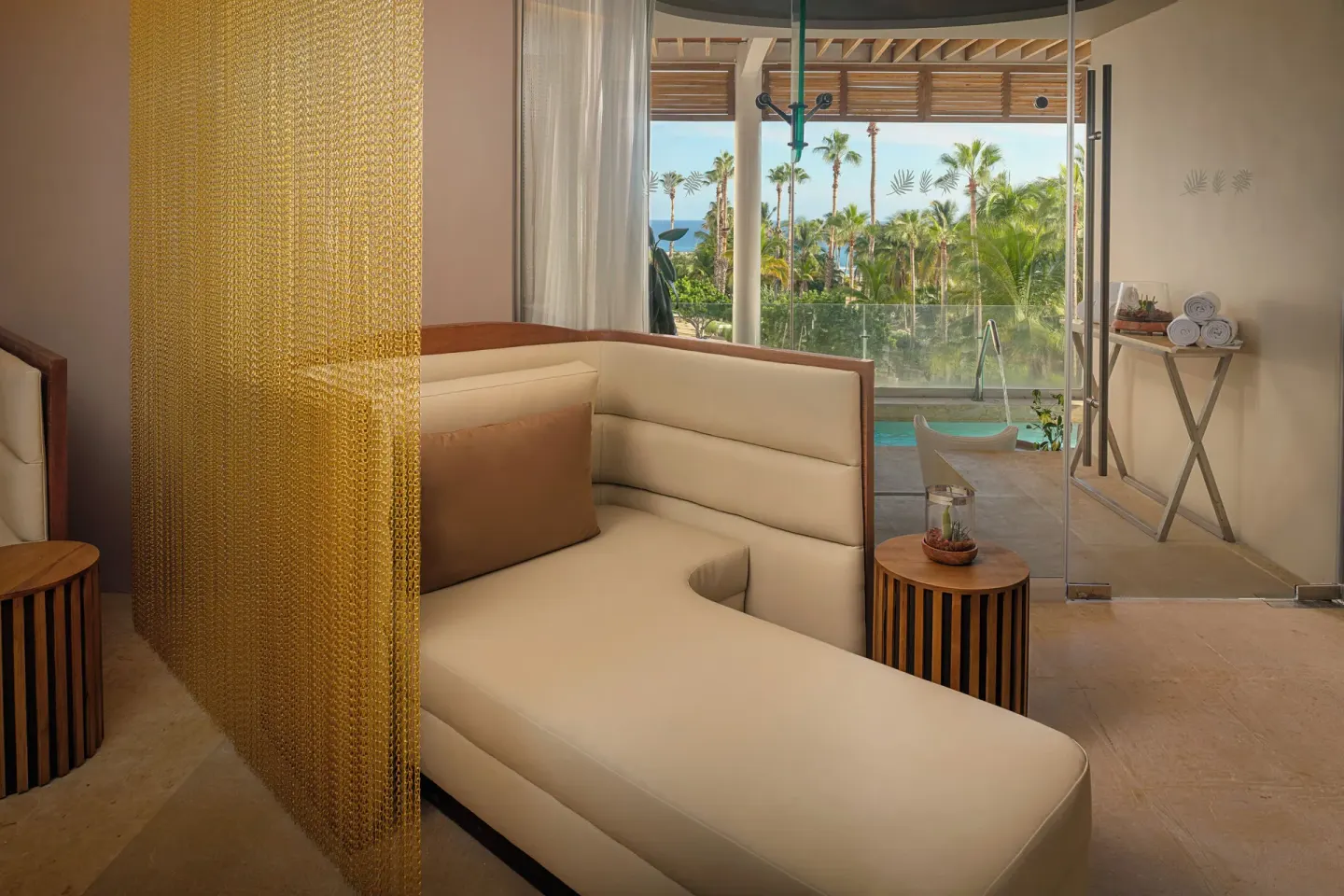 Spa lounge chair beside a glass shower area at Paradisus Los Cabos.