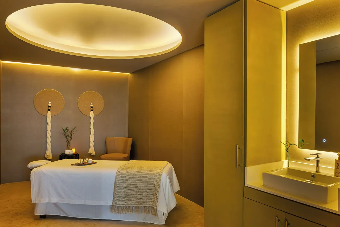 Single spa treatment bed with warm lighting and vanity at Paradisus Los Cabos.