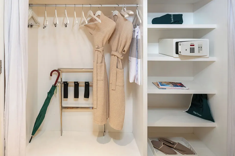 Junior Suite closet with robes, safe, hangers, and umbrella at Paradisus Los Cabos.