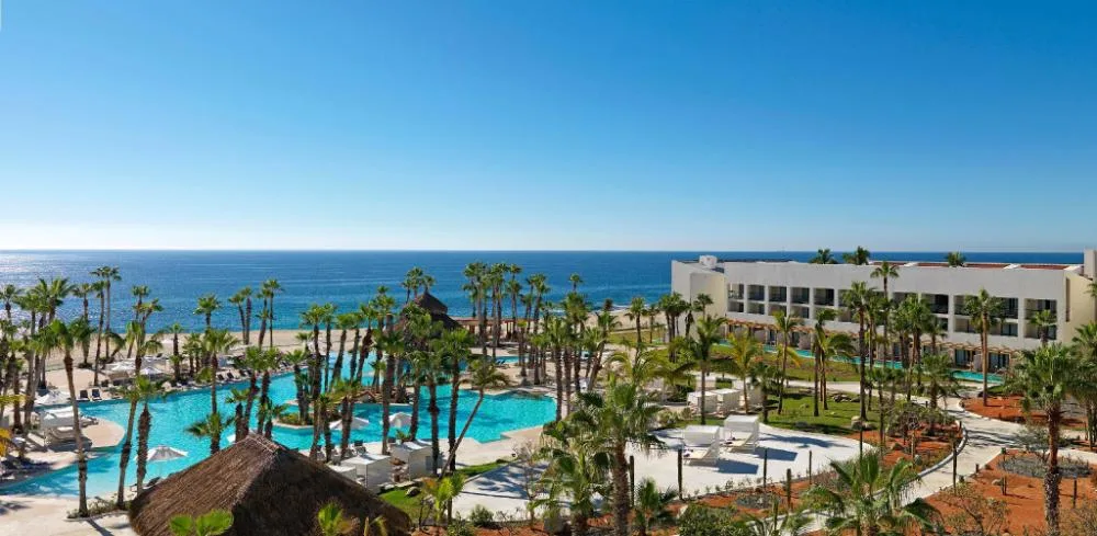 Suite Garden View panorama of pools, palms, gardens, and sea at Paradisus Los Cabos.