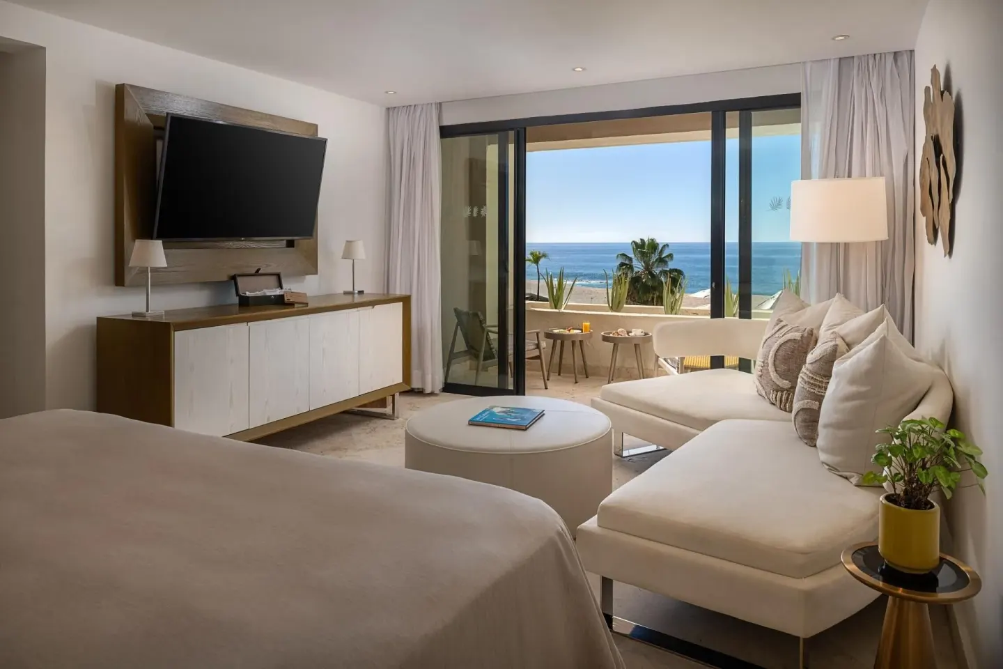The Reserve Master Suite Ocean Front king bed and sitting area at Paradisus Los Cabos.