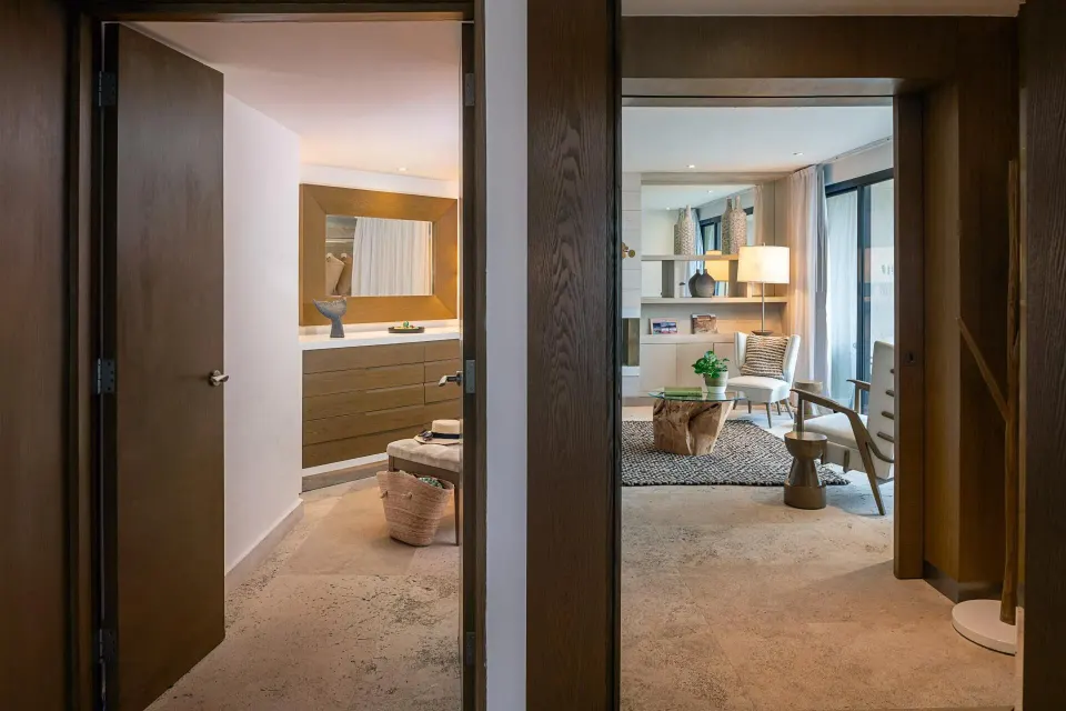 The Reserve Master Suite entry at Paradisus Los Cabos showing bathroom vanity and living room beyond.