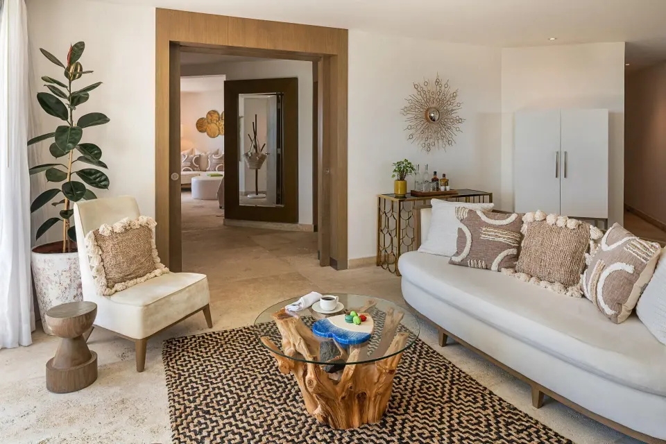 The Reserve Master Suite living room at Paradisus Los Cabos with sofa, lounge chair, and wood coffee table.