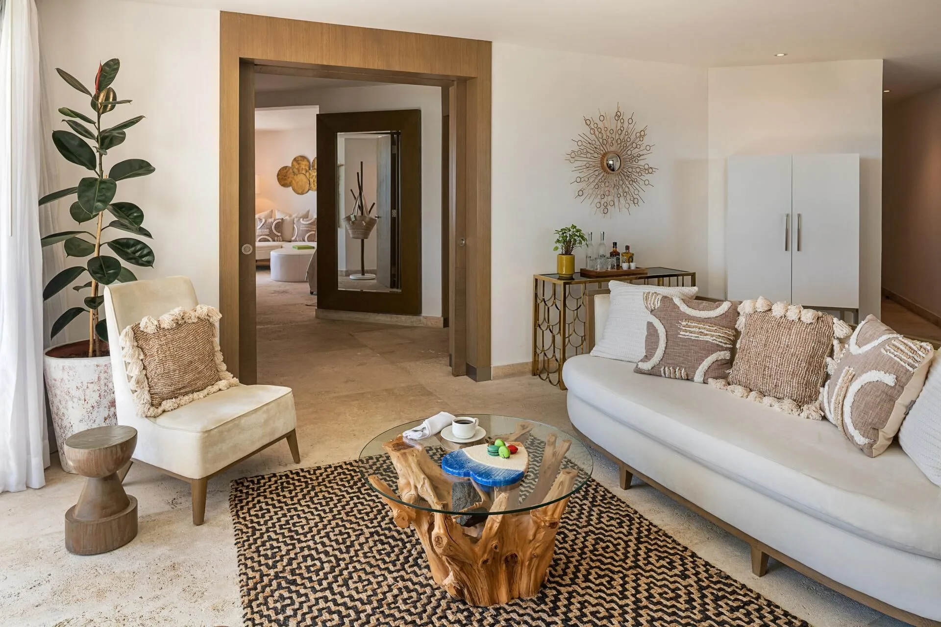 The Reserve Master Suite living room at Paradisus Los Cabos with sofa, lounge chair, and wood coffee table.