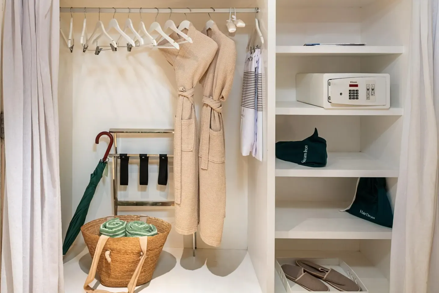 Open closet with robes and safe in The Reserve Suite Garden View at Paradisus Los Cabos.
