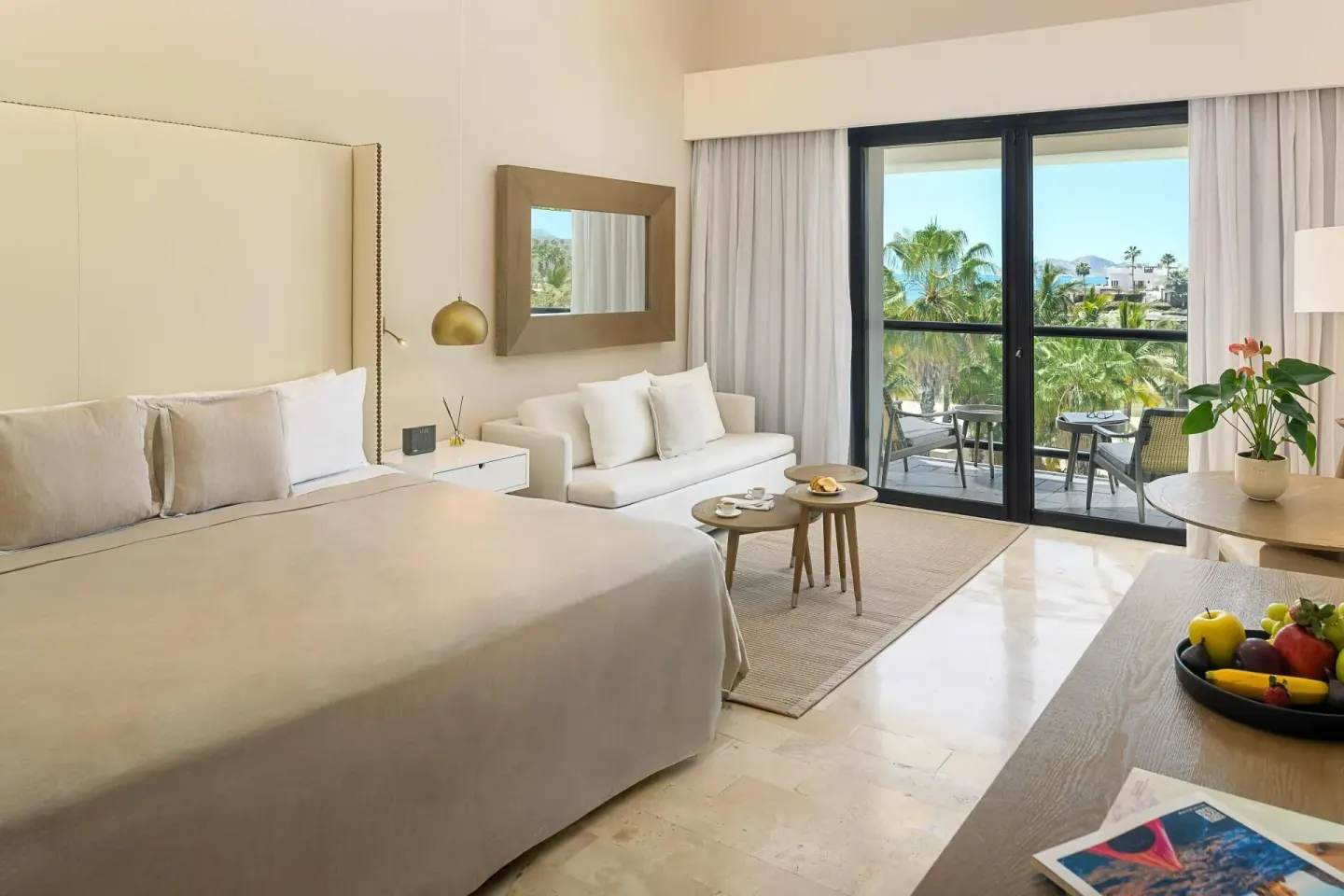 King bed and balcony in The Reserve Suite Garden View at Paradisus Los Cabos.