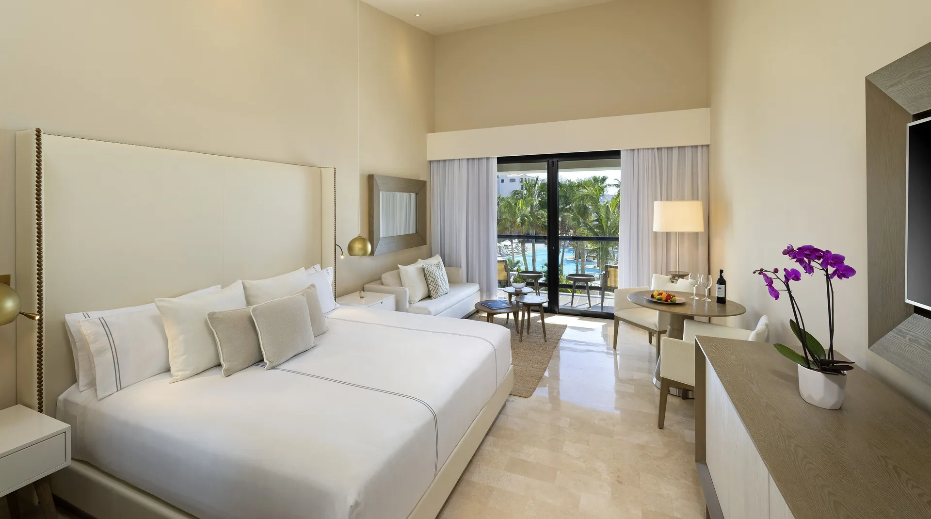 The Reserve Suite Ocean View king bed and balcony at Paradisus Los Cabos.