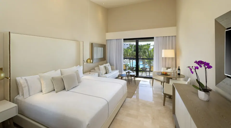 The Reserve Suite Ocean View bedroom with king bed and balcony at Paradisus Los Cabos.