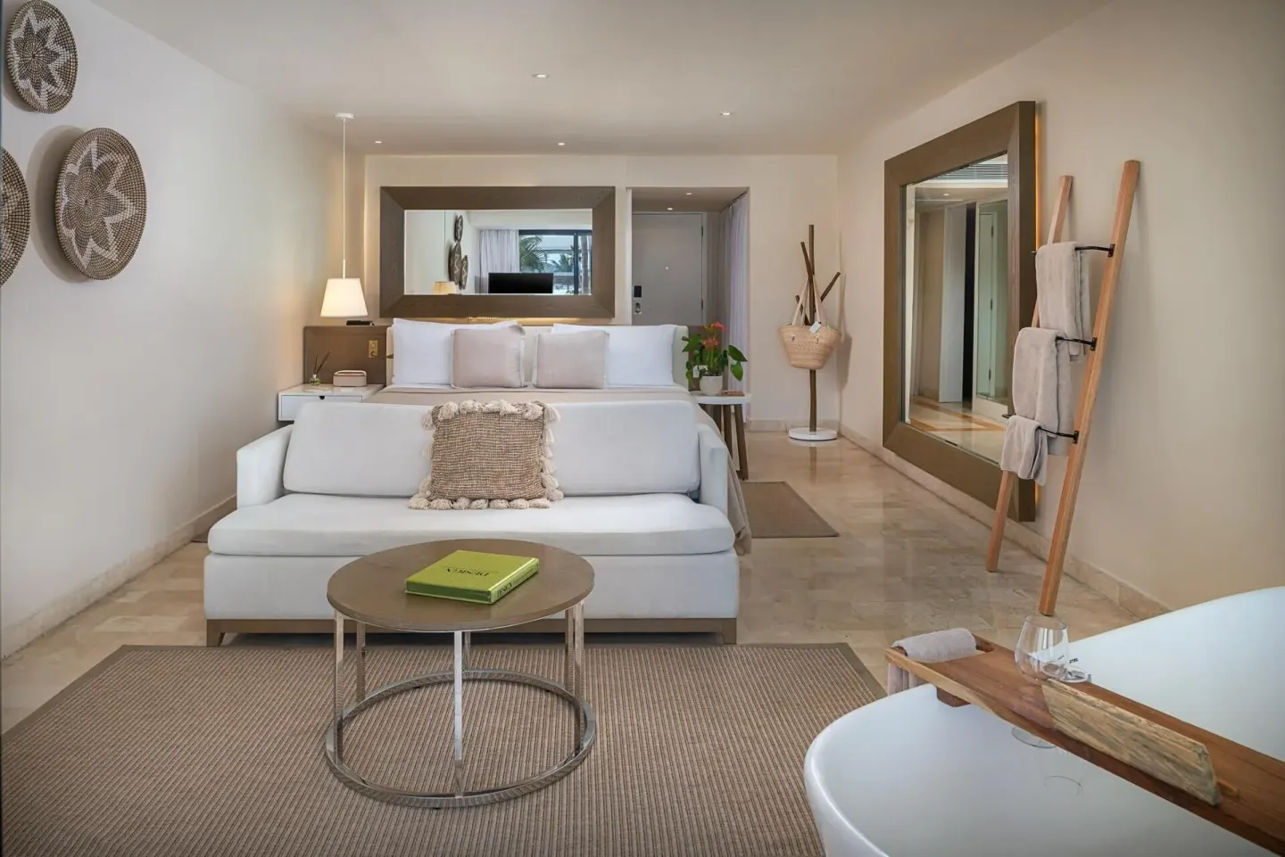 The Reserve Suite Swim-Up bedroom with sofa and soaking tub at Paradisus Los Cabos.