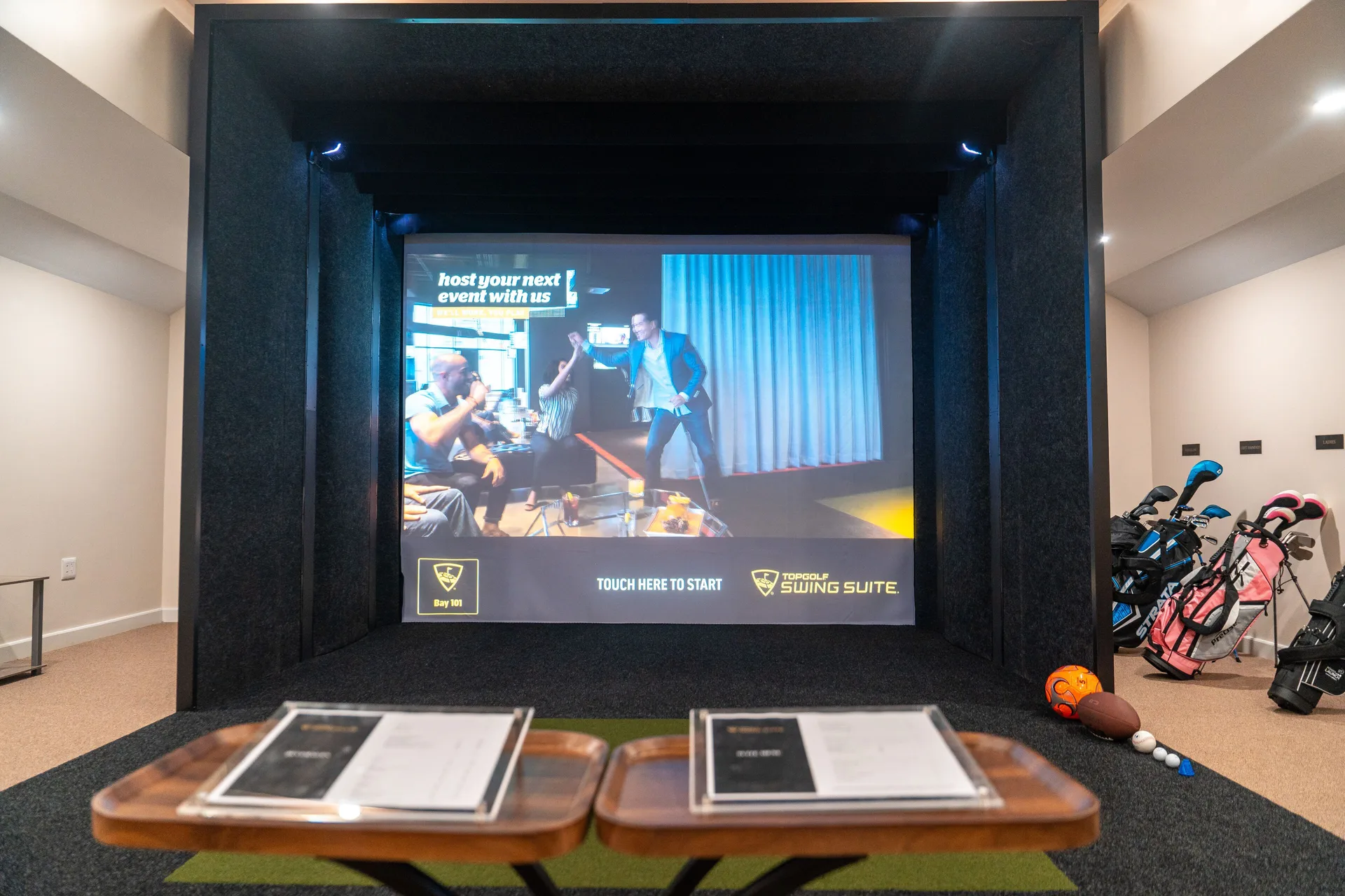 Indoor golf simulator bay with clubs and seating at Park Hyatt St. Kitts.