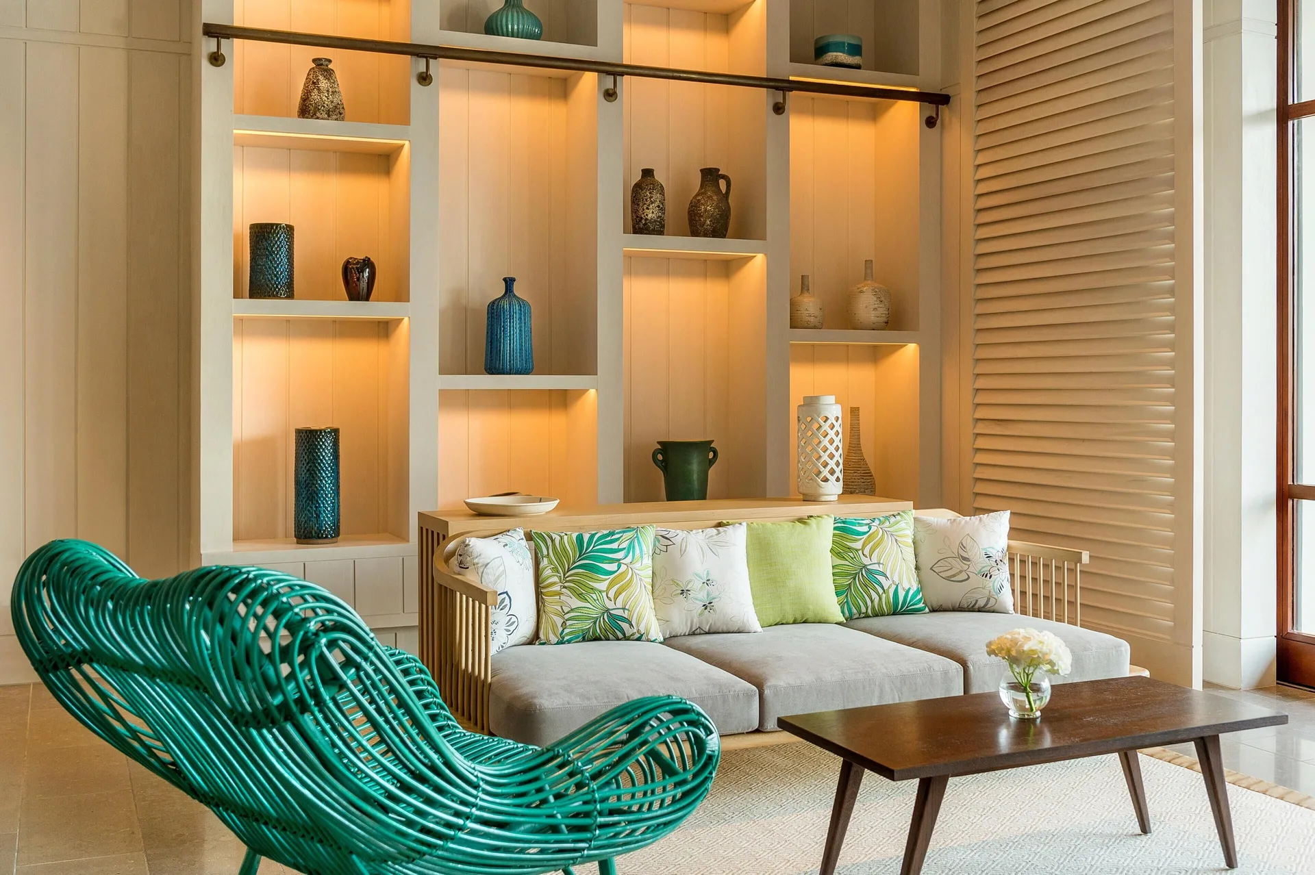 Decorative lobby seating with green woven chairs and display shelves at Park Hyatt St. Kitts.
