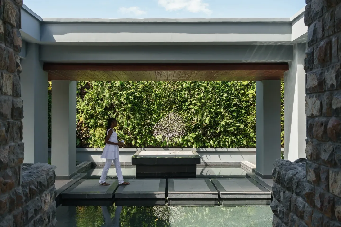 Covered spa walkway with water and a living green wall at Park Hyatt St. Kitts.