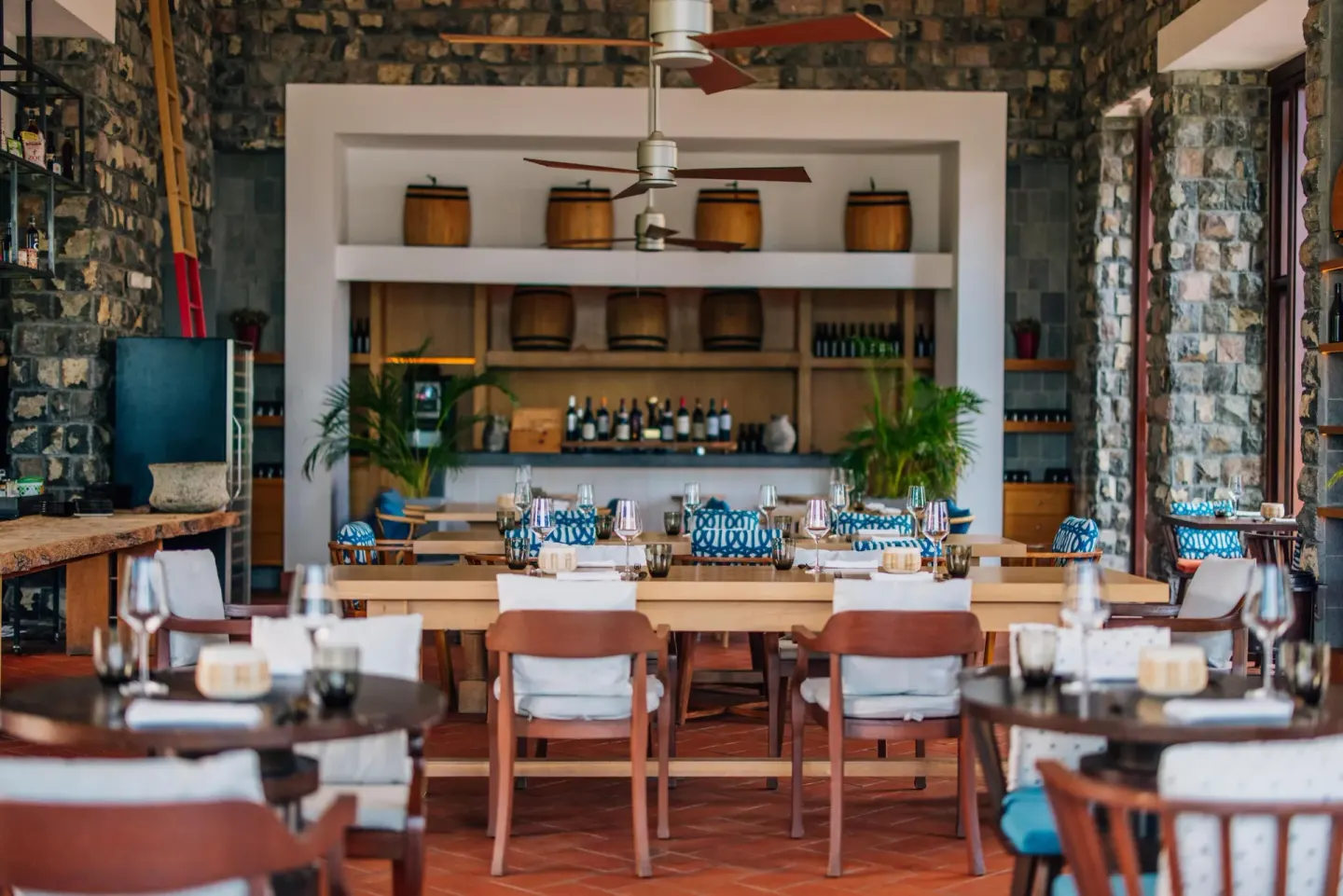 Dining room with stone walls and wine shelves at Park Hyatt St. Kitts.