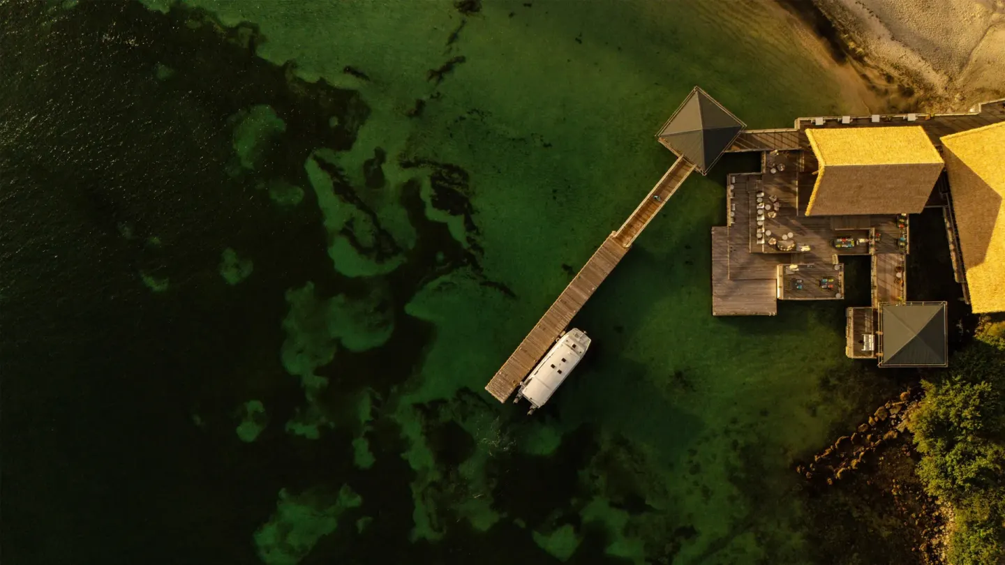 Aerial view of a pier and overwater restaurant at Park Hyatt St. Kitts.