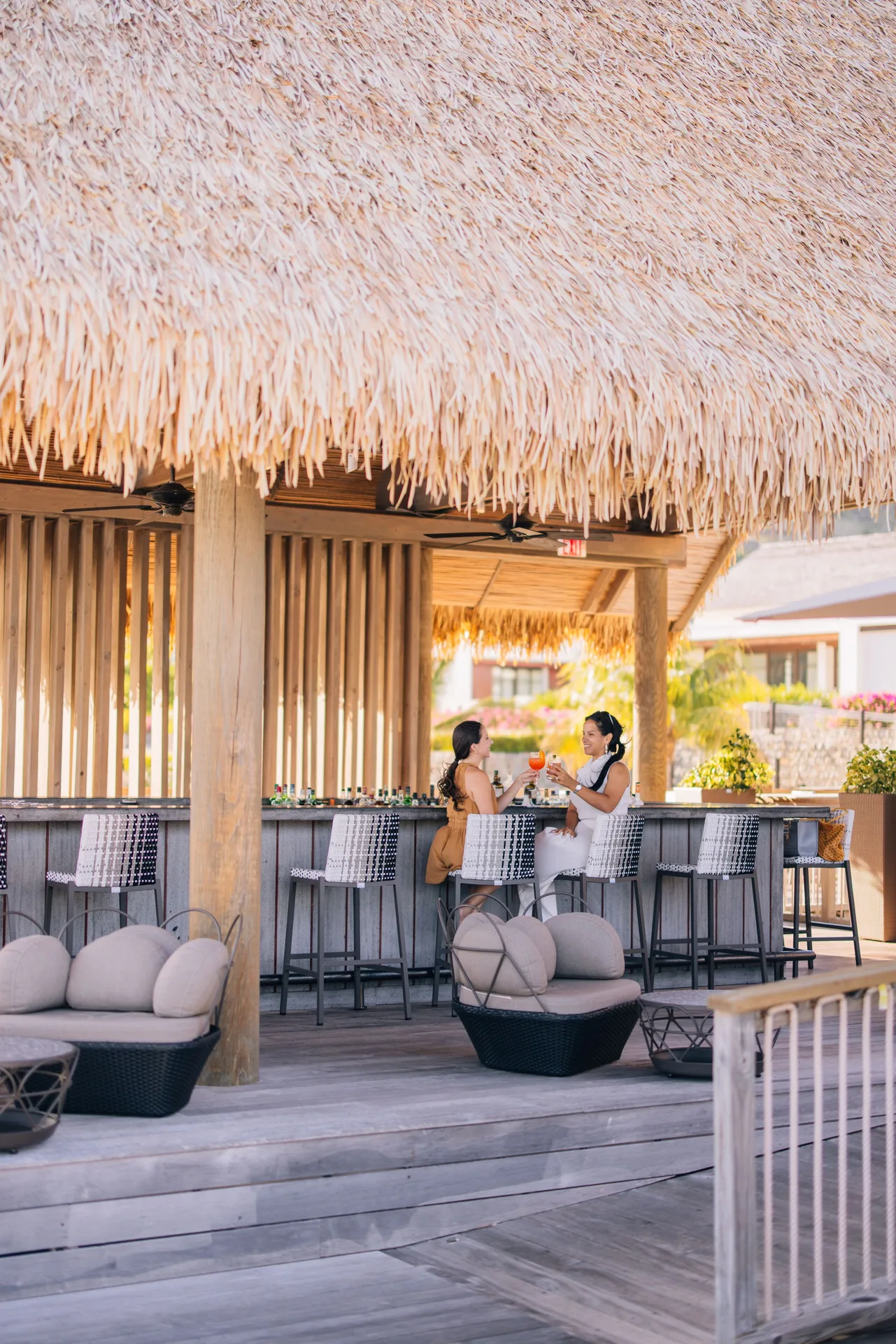 Thatched open-air bar with guests at the counter at Park Hyatt St. Kitts.