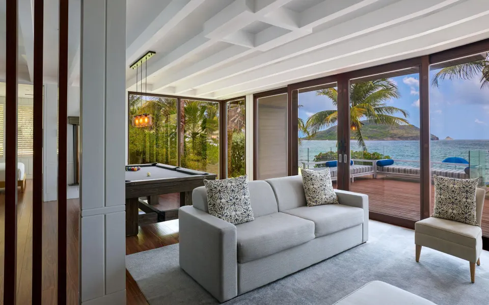 Presidential Villa lounge with pool table and ocean terrace at Park Hyatt St. Kitts.