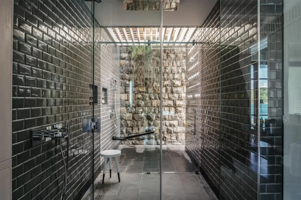 Presidential Villa shower with dark tile and glass doors at Park Hyatt St. Kitts.