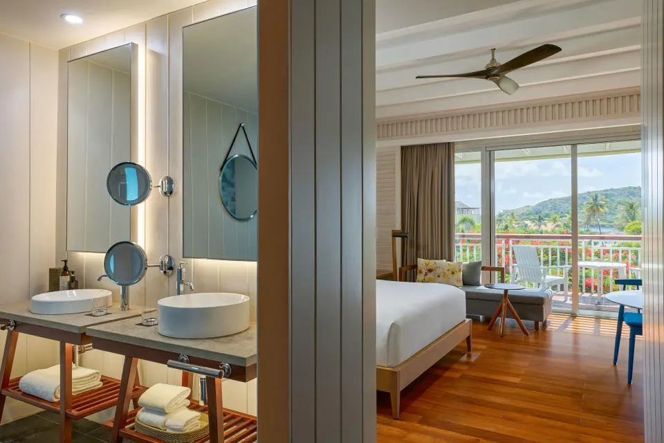 Accessible room vanity and king bed with balcony beyond at Park Hyatt St. Kitts.