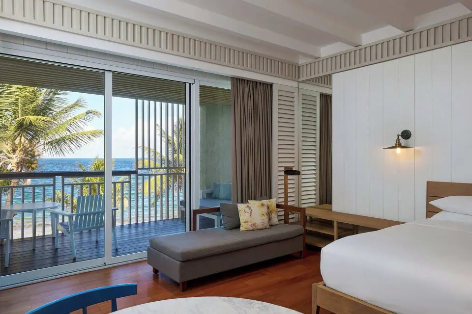 Beachfront room with king bed, chaise and ocean-facing balcony at Park Hyatt St. Kitts.