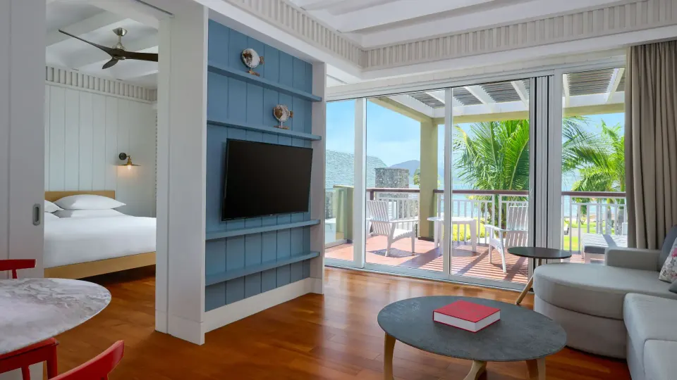 Ocean View room living area, king bed, balcony, and sea beyond at Park Hyatt St. Kitts.