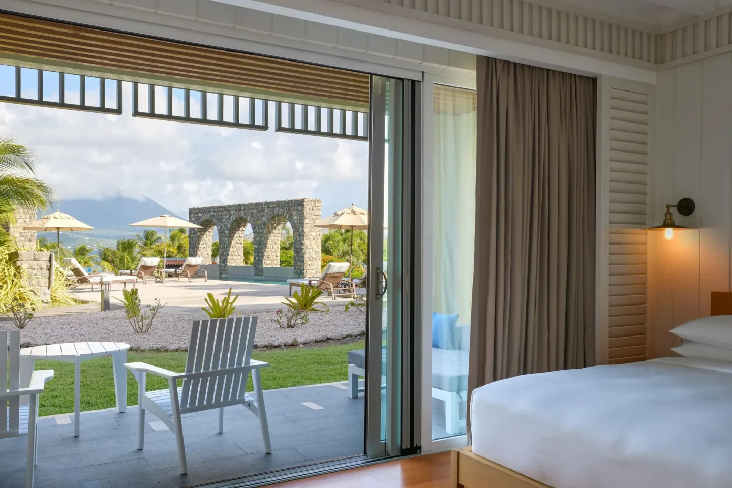 Pool View Room king bed opening to a patio at Park Hyatt St. Kitts.