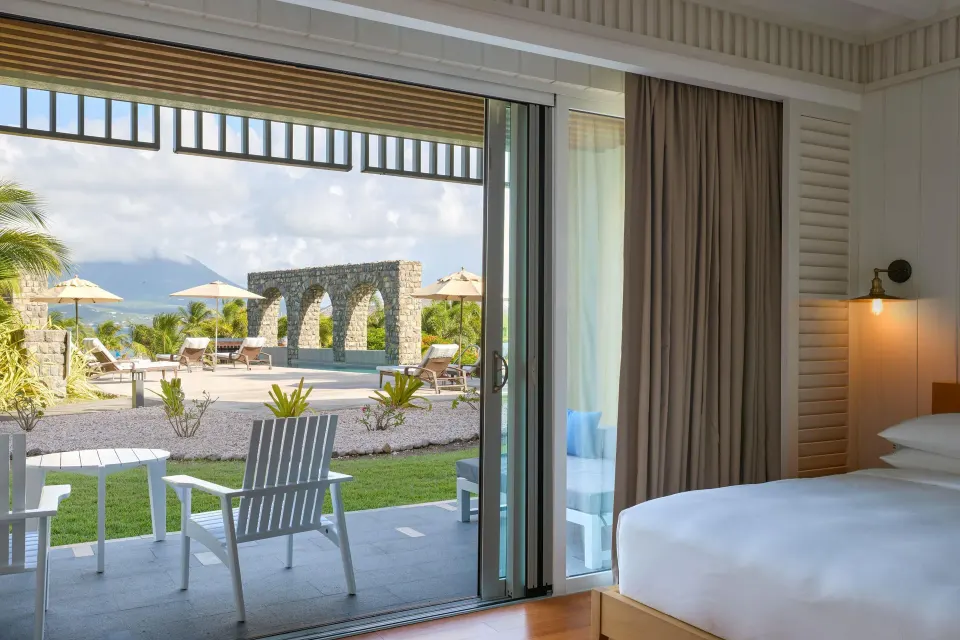 Pool View Room king bed opening to a patio at Park Hyatt St. Kitts.