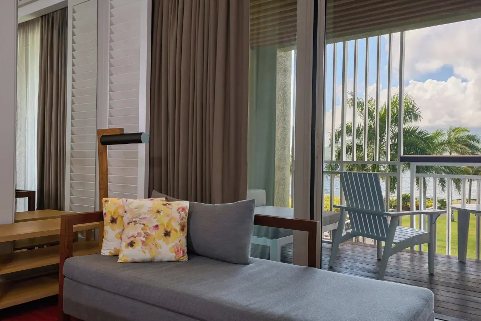 Guest room chaise and balcony seating with tropical view at Park Hyatt St. Kitts.