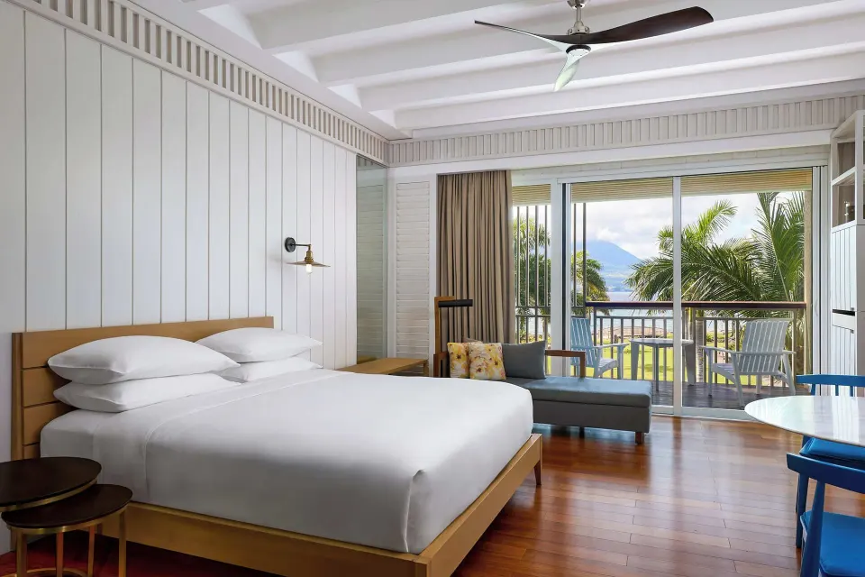King-bed guest room with balcony and sea view at Park Hyatt St. Kitts.