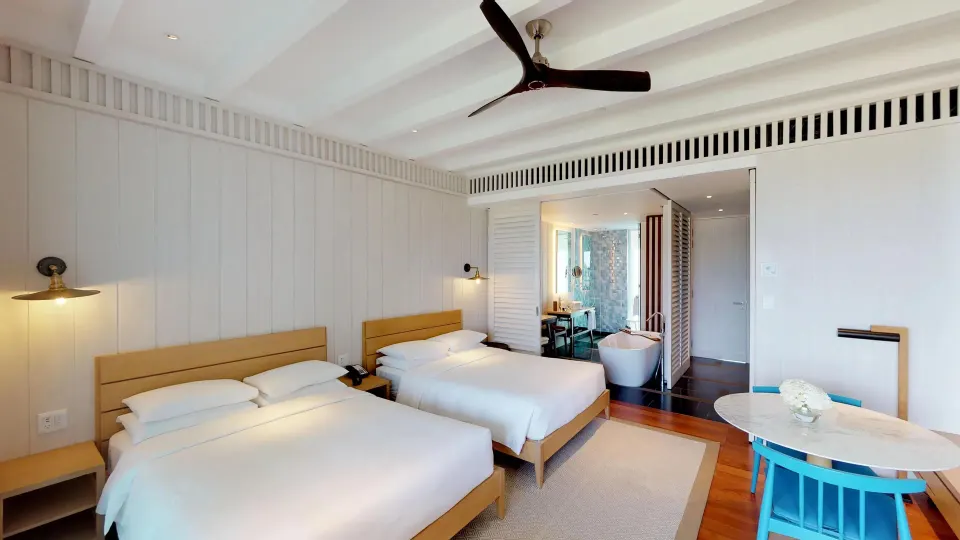 Two-bed guest room with open bathroom area at Park Hyatt St. Kitts.