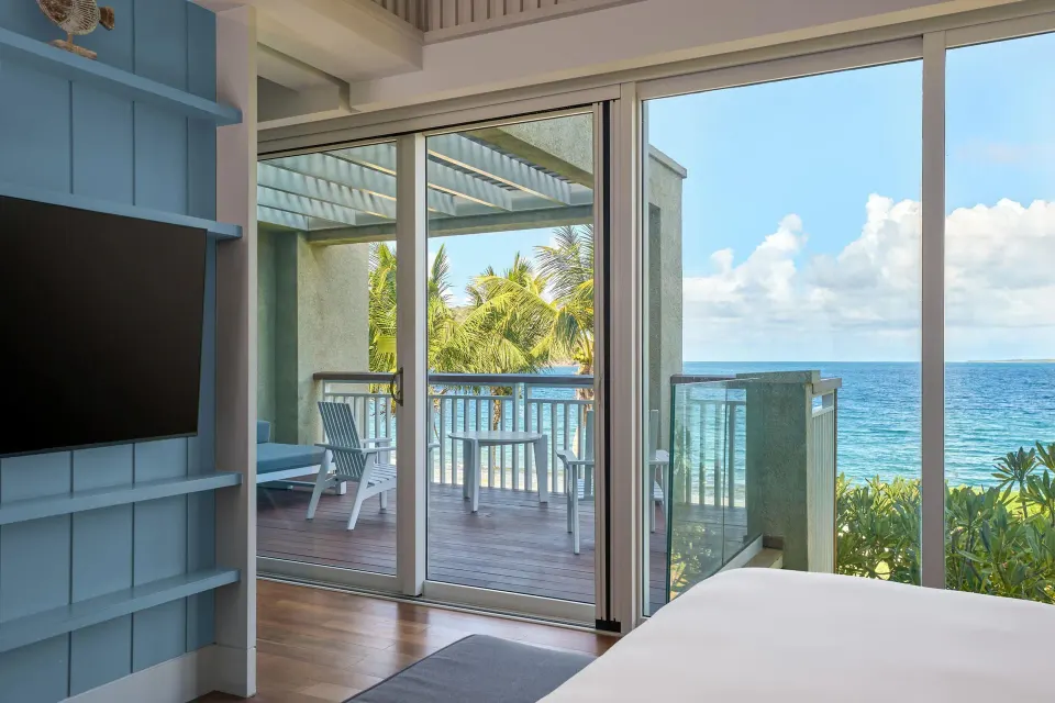 Beachfront suite bedroom with balcony and ocean view at Park Hyatt St. Kitts.
