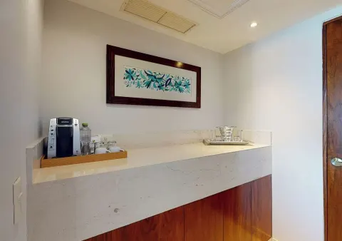 Guest room refreshment counter with coffee maker at Park Royal Beach Cancun.