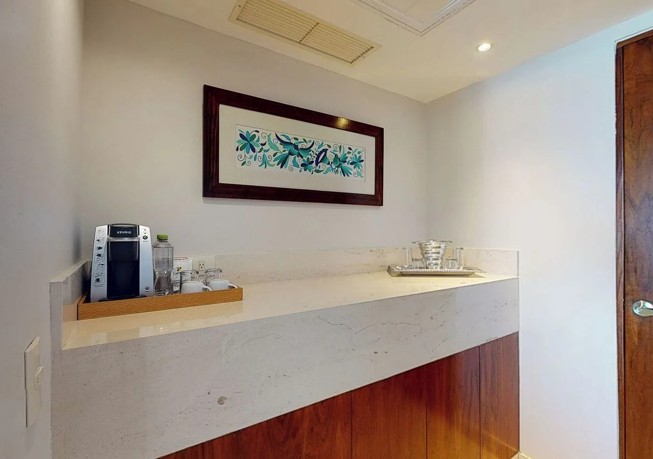 Guest room refreshment counter with coffee maker at Park Royal Beach Cancun.