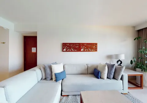 Suite living area with sectional sofa at Park Royal Beach Cancun.
