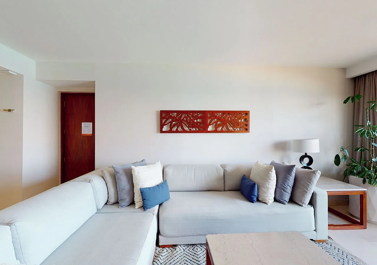 Suite living area with sectional sofa at Park Royal Beach Cancun.
