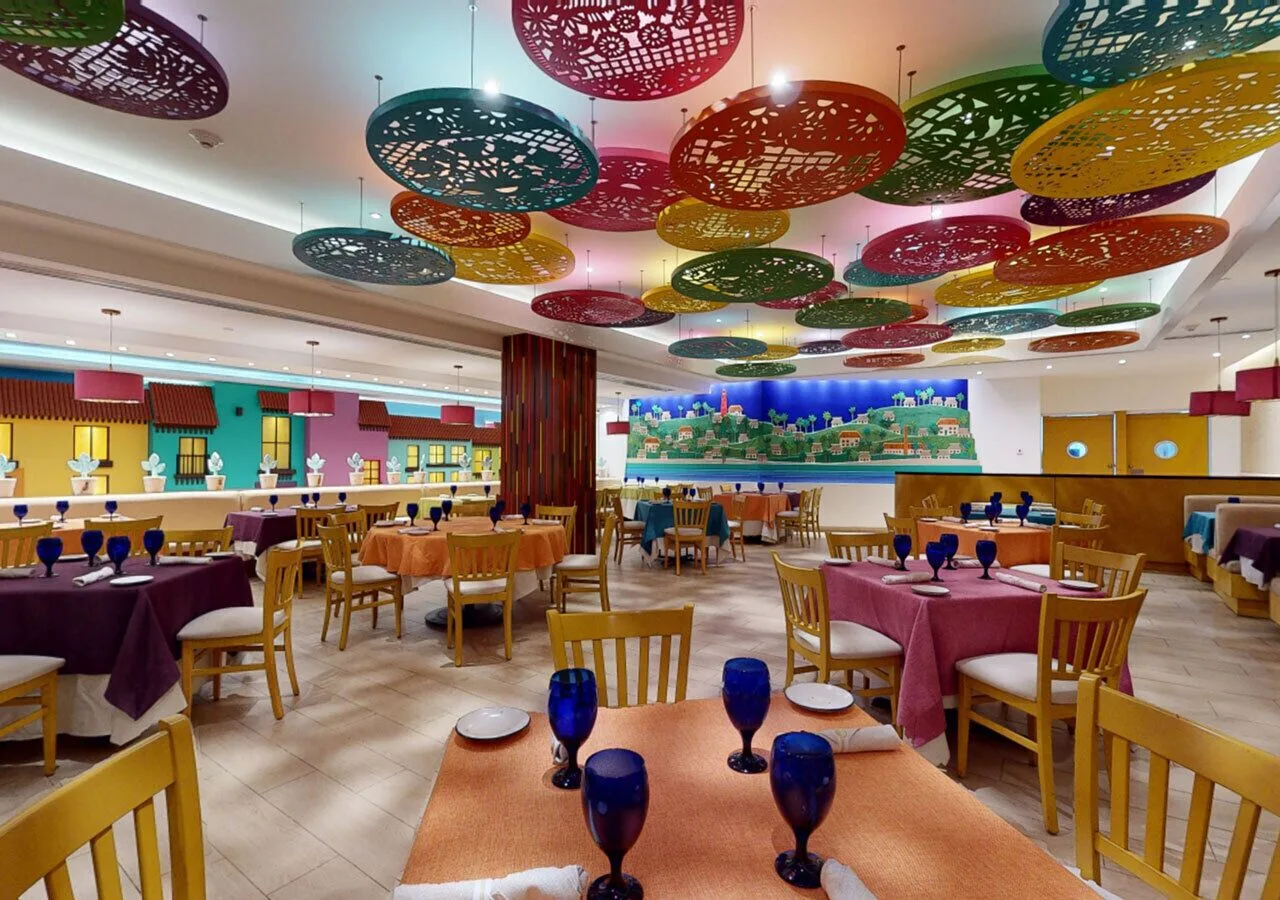 Colorful restaurant dining room at Park Royal Beach Cancun with patterned ceiling decorations.