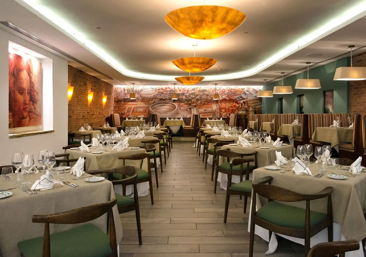 Formal restaurant dining room at Park Royal Beach Cancun with set tables and warm lighting.