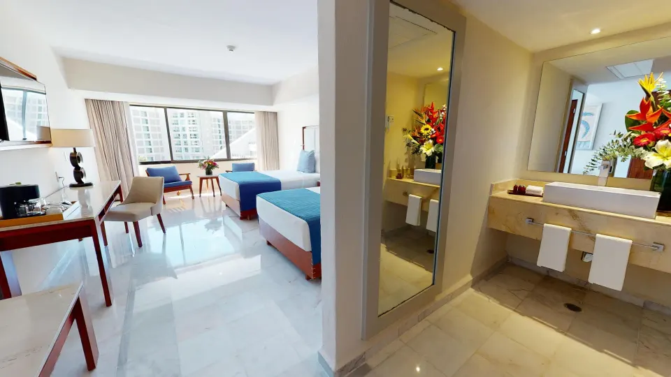 Deluxe Superior room with two beds and bathroom vanity at Park Royal Beach Cancun.