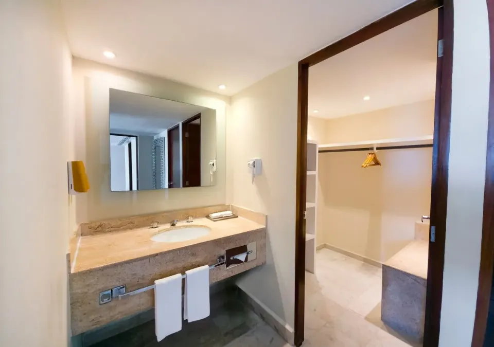 Family Suite bathroom vanity and open closet area at Park Royal Beach Cancun.