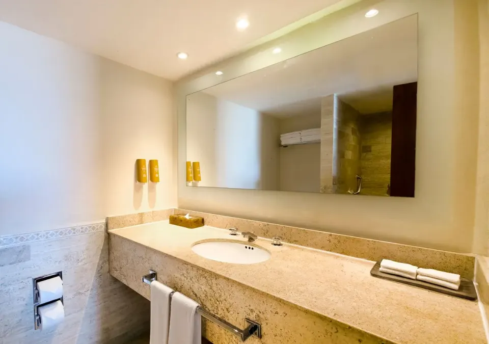 Family Suite bathroom vanity with sink and mirror at Park Royal Beach Cancun.