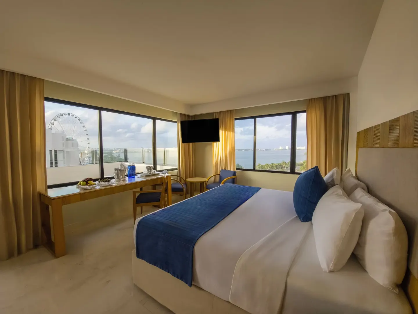 Honeymoon Room king bed with corner windows at Park Royal Beach Cancun.